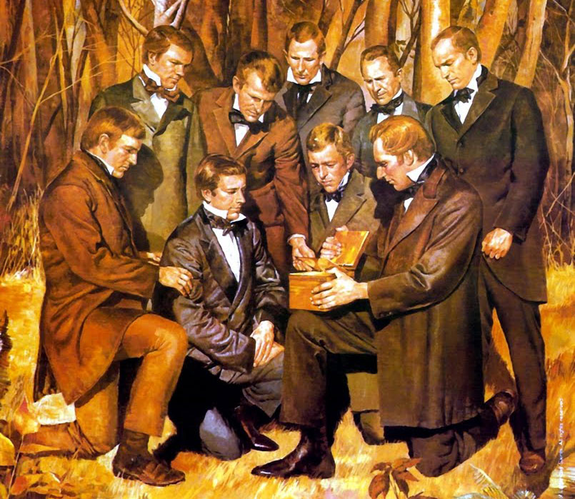 A painting. Joseph Smith, Jr. kneels with one knee on the ground, holding the golden plates on his other knee. Three men kneel close to him, looking at the plates, and five other men surround them, looking at the plates.